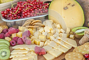 Cheese and fruits on a beautifully vintage decorated table