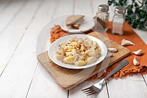 Cheese gnocchi with cheese sauce and bacon bits