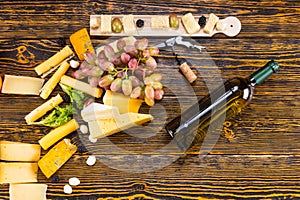 Cheese, Grapes and Bottle of Wine on Wooden Table