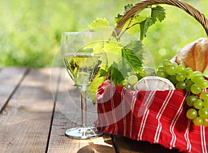 Cheese, grapes, bread and two glasses of the white wine