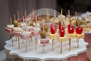 cheese and ham skewer with cherries and olives photo