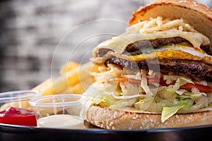 Cheese hamburgers sandwich with fried potatoes with black background, nice