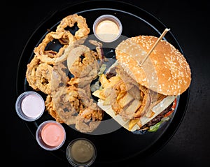 Cheese hamburgers sandwich with fried potatoes with black background, nice