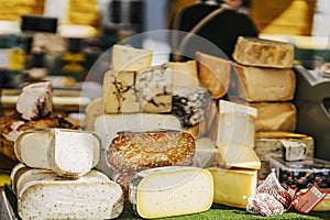 Cheese heads on market counter on market counter. Gastronomic dainty products, real scene, food market