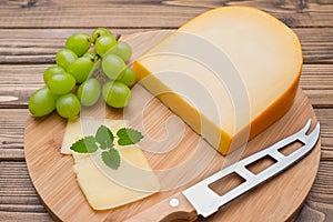 Cheese with knife on board