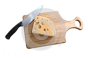 Cheese and knife on bread board