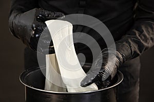 Cheese maker preparing mozzarella cheese