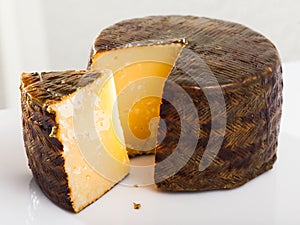 Cheese manchego with cut piece photo