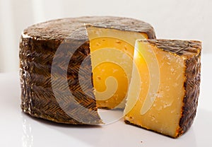 Cheese manchego with cut piece photo