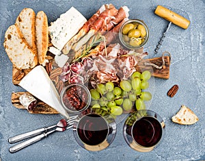 Cheese and meat appetizer selection or wine snack set. Variety of cheese, salami, prosciutto, bread sticks, baguette
