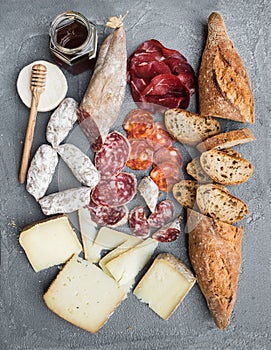 Cheese and meat appetizer selection or wine snack set. Variety of italian cheese, salami, bresaola, baguette, honey on