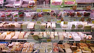 Cheese, mozzarella. Shelving fridge with edible products. Store.