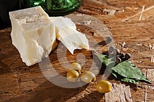 Cheese and olives on wooden surface