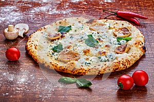 Cheese pizza with mushrooms on a wooden table
