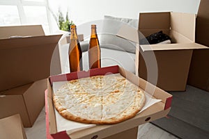 Pizza, beer and boxes, moving in celebration housewarming party photo