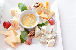 Cheese plate Assortment of various types of cheese on white plate