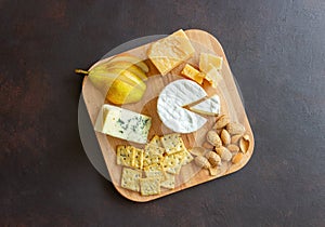 Cheese plate with cracker, almonds and grapes. Wine appetizer. Wine snack