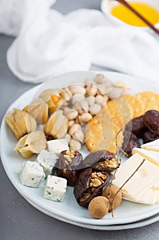 Cheese plate with crackers, dates and nuts