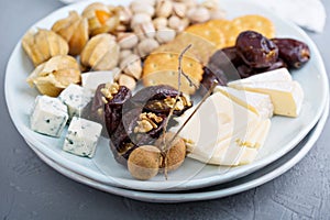 Cheese plate with crackers, dates and nuts