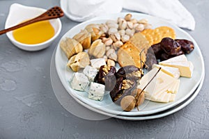 Cheese plate with crackers, dates and nuts