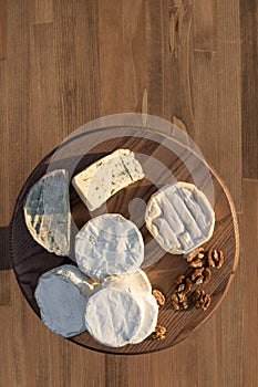 Cheese plate. different cheeses on a wooden plate