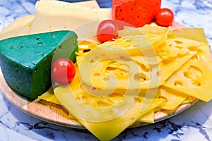 Cheese plate with fresh small red tomatoes