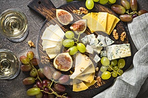 Cheese plate with grapes, figs and nuts.