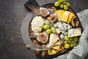 Cheese plate with grapes, figs and nuts.