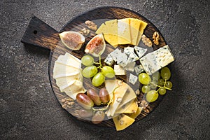 Cheese plate with grapes, figs and nuts.