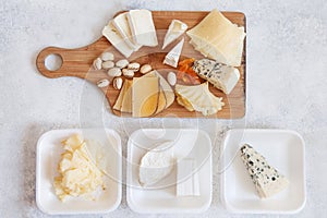 Cheese plate served with grapes, jam, cured melon, crackers and