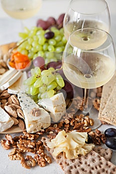 Cheese plate served with grapes, jam, cured melon, crackers and