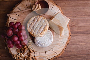 Cheese plate on a wooden table. rustic