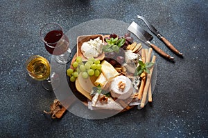 Cheese platter with assorted cheeses, grapes, nuts and snacks