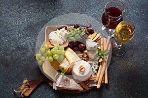 Cheese platter with assorted cheeses, grapes, nuts and snacks