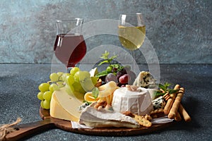 Cheese platter with assorted cheeses, grapes, nuts and snacks