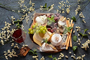 Cheese platter with assorted cheeses, grapes, nuts and snacks