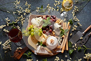 Cheese platter with assorted cheeses, grapes, nuts and snacks