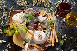 Cheese platter with assorted cheeses, grapes, nuts and snacks