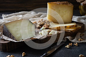 Cheese platter of chopped Spanish hard cheese manchego and sliced Italian pecorino toscano photo