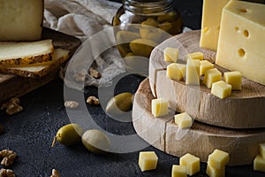 Cheese platter of chopped Swedish hard cheese and sliced and Italian pecorino toscano on wooden boards