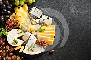 Cheese platter with craft cheese assortment on slate board.