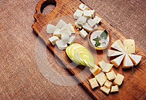 Cheese platter garnished with honey and apple