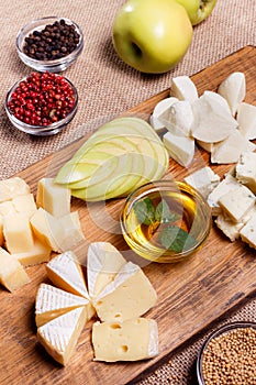 Cheese platter garnished with honey, apple and spice