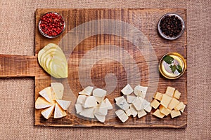 Cheese platter garnished with honey, apple and spice