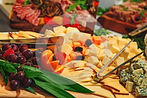 Cheese platter and mixed fruit made to suit whichever occasion as catering table. Different varieties of cheese.