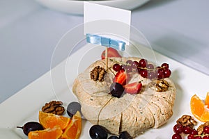Cheese platter with organic cheese, fruits, nuts.