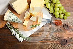 Cheese platter with rosemary, grapes and fork