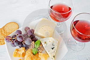 Cheese platter and two glasses of red wine