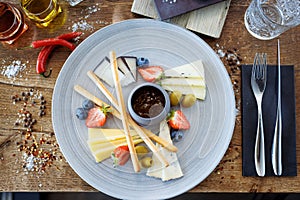 Cheese platter for two: Goat cheese cream, gorgonzola, camembert, grissini and fig jam. Delicious healthy Italian