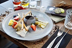 Cheese platter for two: Goat cheese cream, gorgonzola, camembert, grissini and fig jam. Delicious healthy Italian